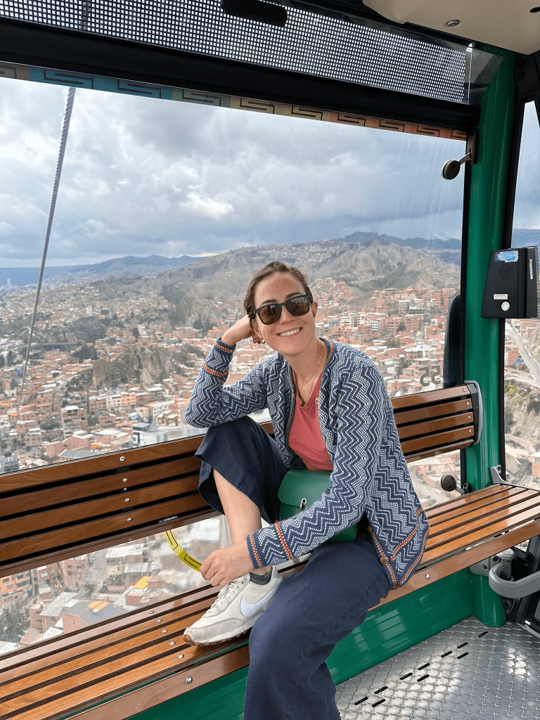 woman in a gondola overlooking a city