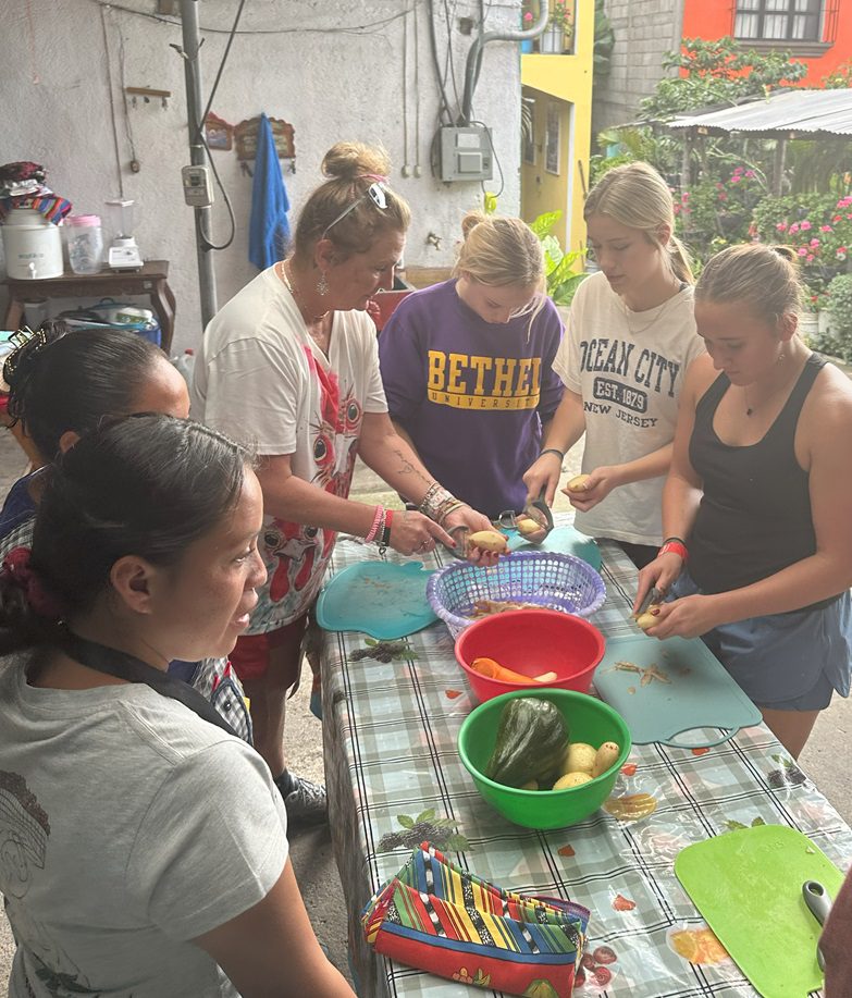 small group around table preparing food