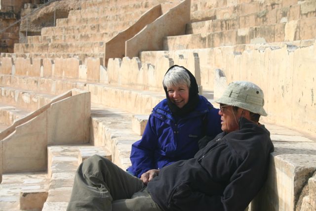 older couple sitting on ruins
