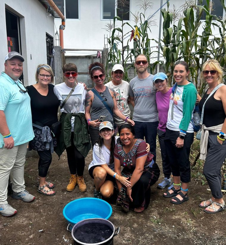 group of adults and students with local teachers